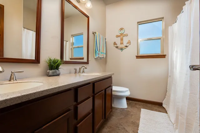 a bathroom with a double vanity sink and a mirror