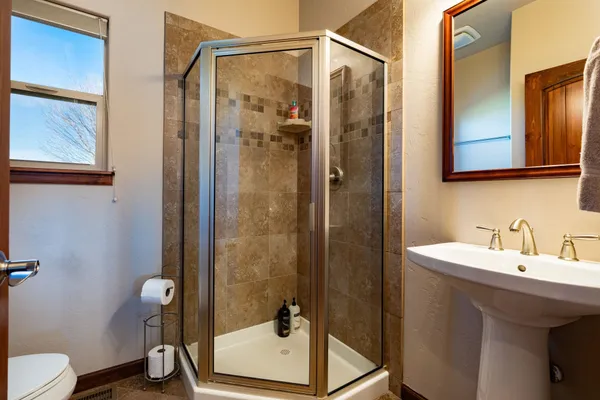a bathroom with a shower and a sink