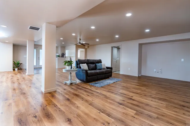 a living room with furniture and a wooden floor