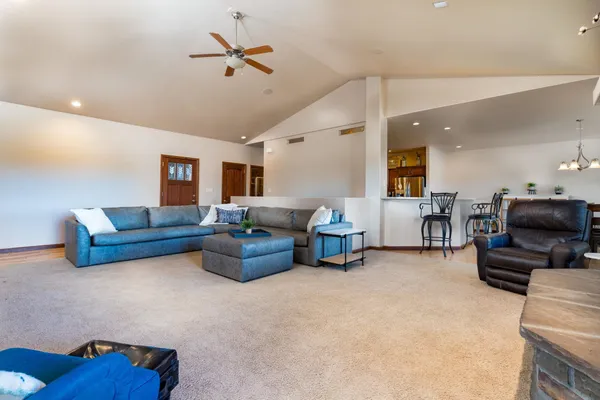 a living room with furniture and kitchen view