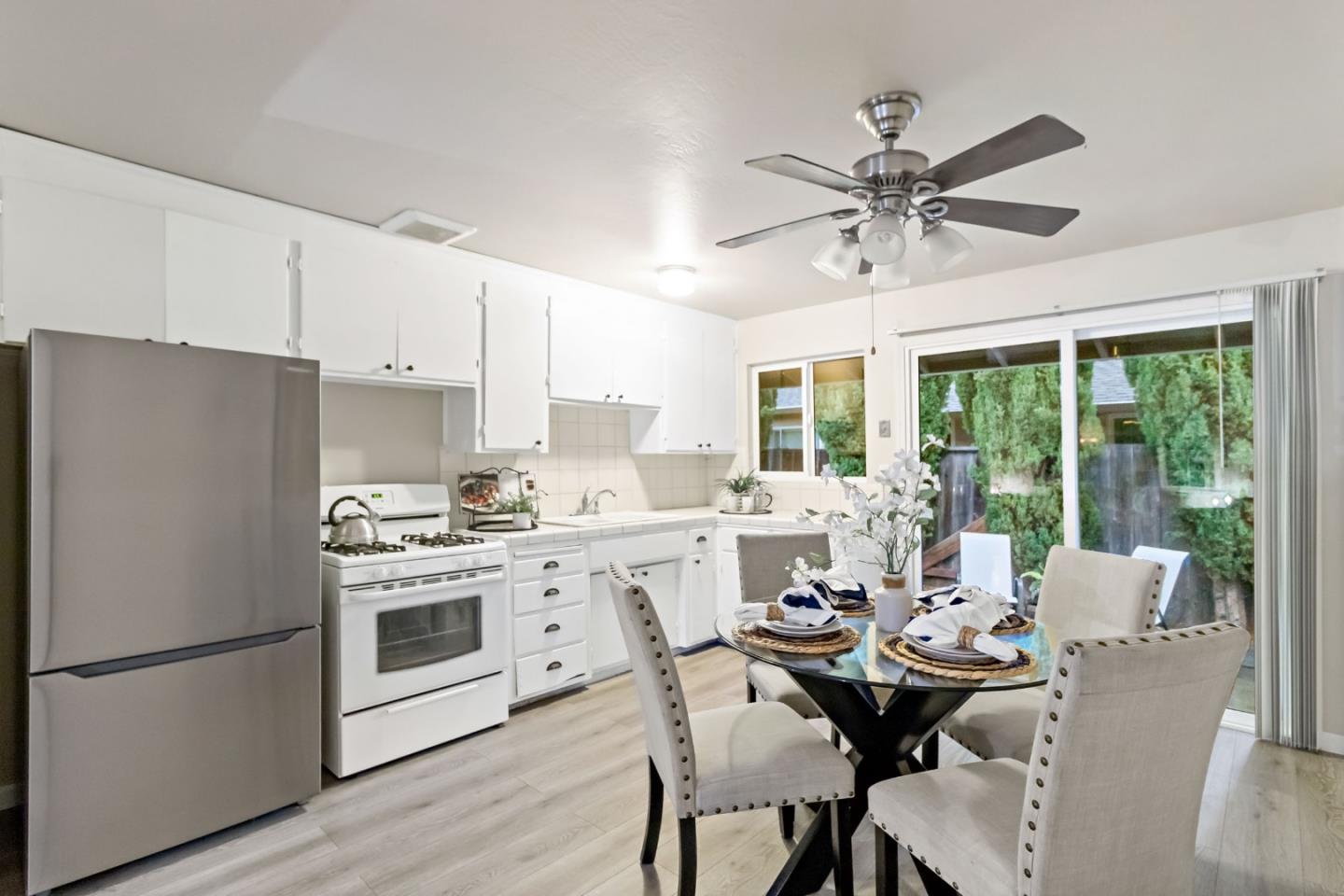 527 Easy Street Mountain View, CA 94043 - Photo 11 of 57 a kitchen with stainless steel appliances a stove a refrigerator a dining table and chairs