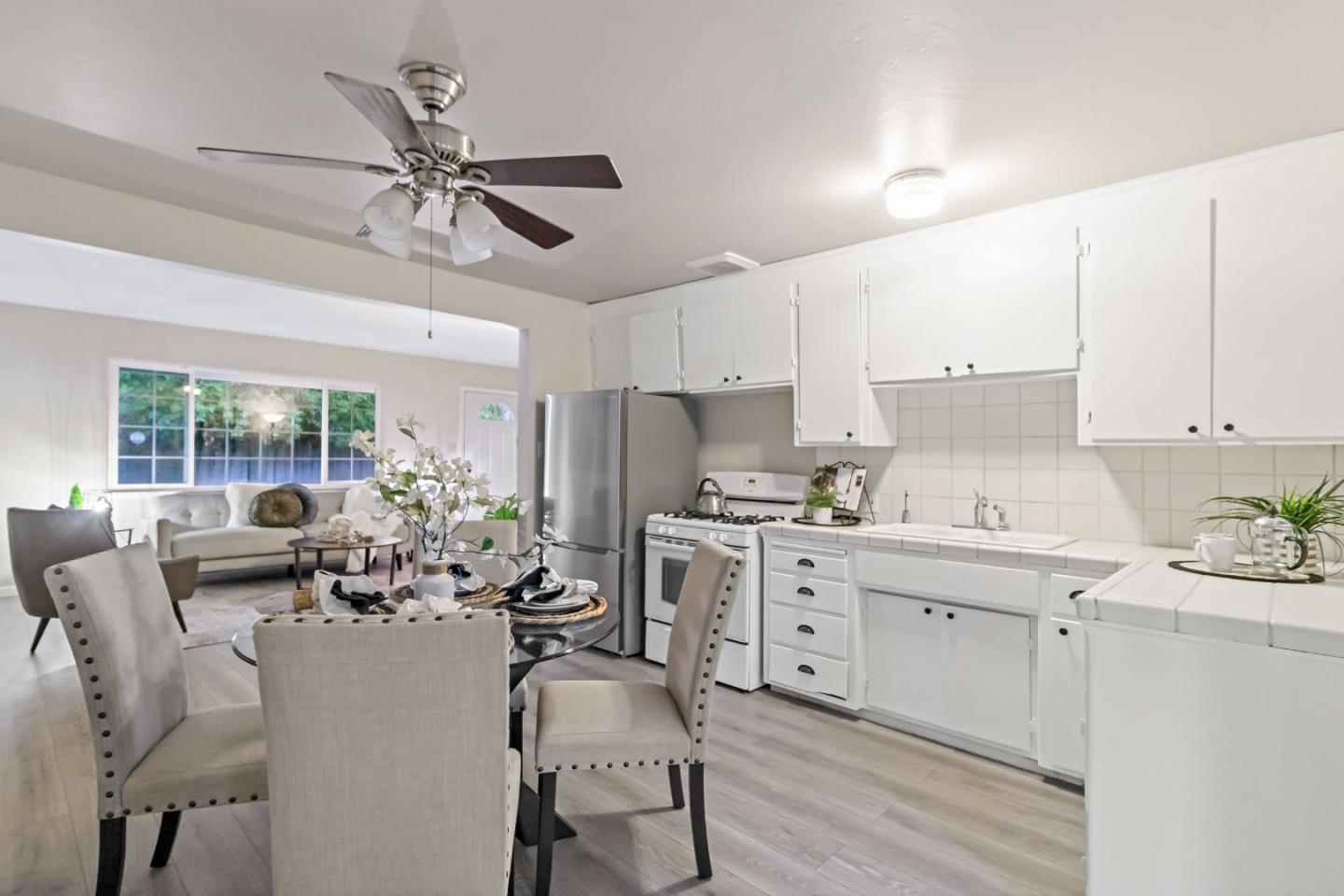 527 Easy Street Mountain View, CA 94043 - Photo 12 of 57 a kitchen with a table chairs stove and cabinets