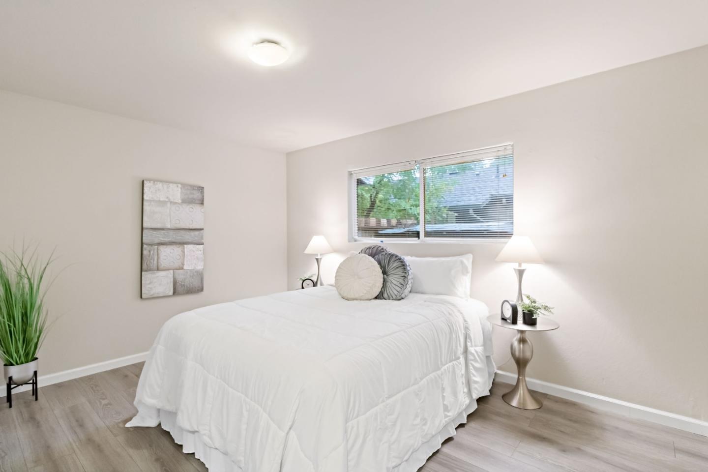 527 Easy Street Mountain View, CA 94043 - Photo 13 of 57 a bedroom with a bed and a potted plant