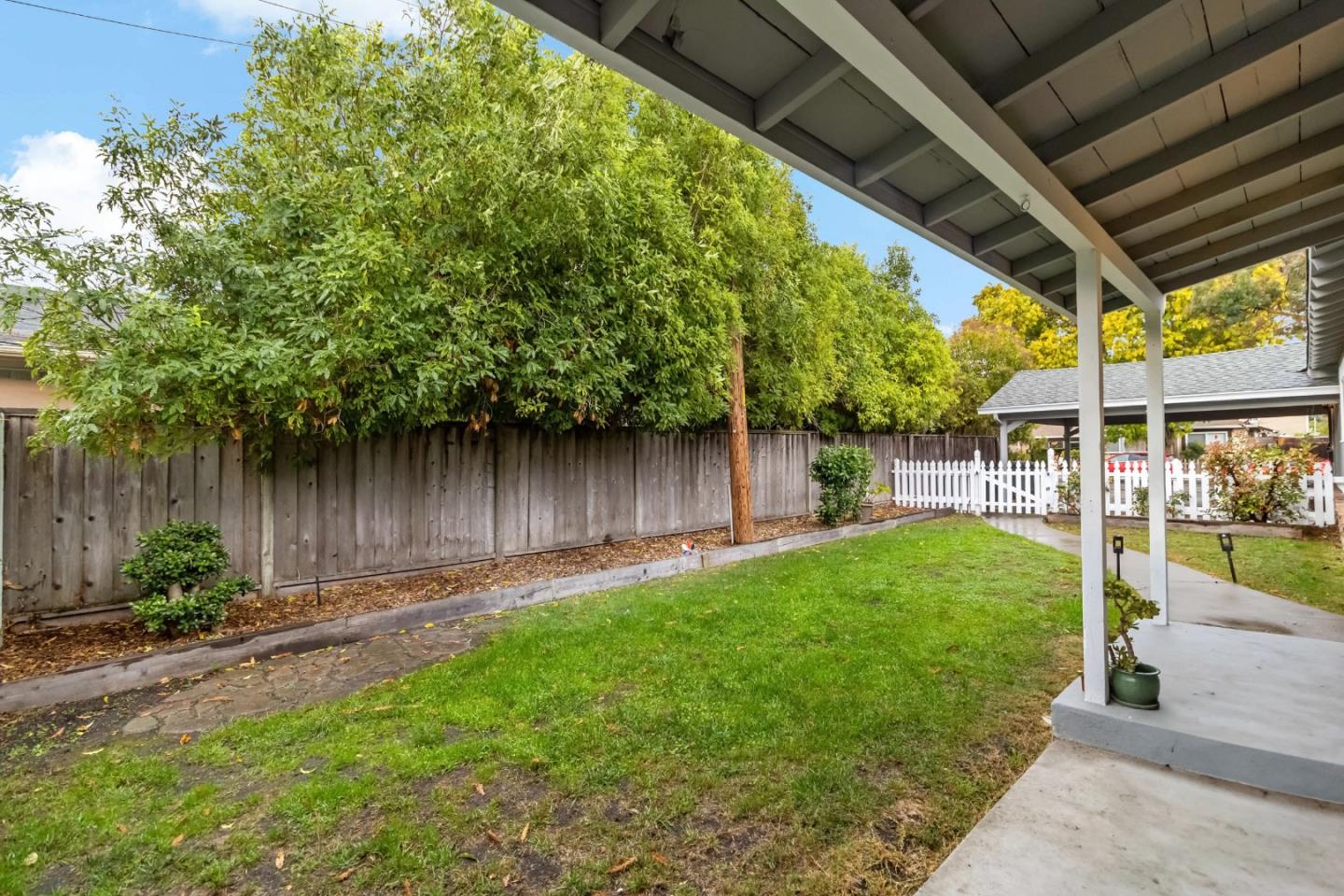 527 Easy Street Mountain View, CA 94043 - Photo 25 of 57 a view of a backyard with table and chairs potted plants and large tree