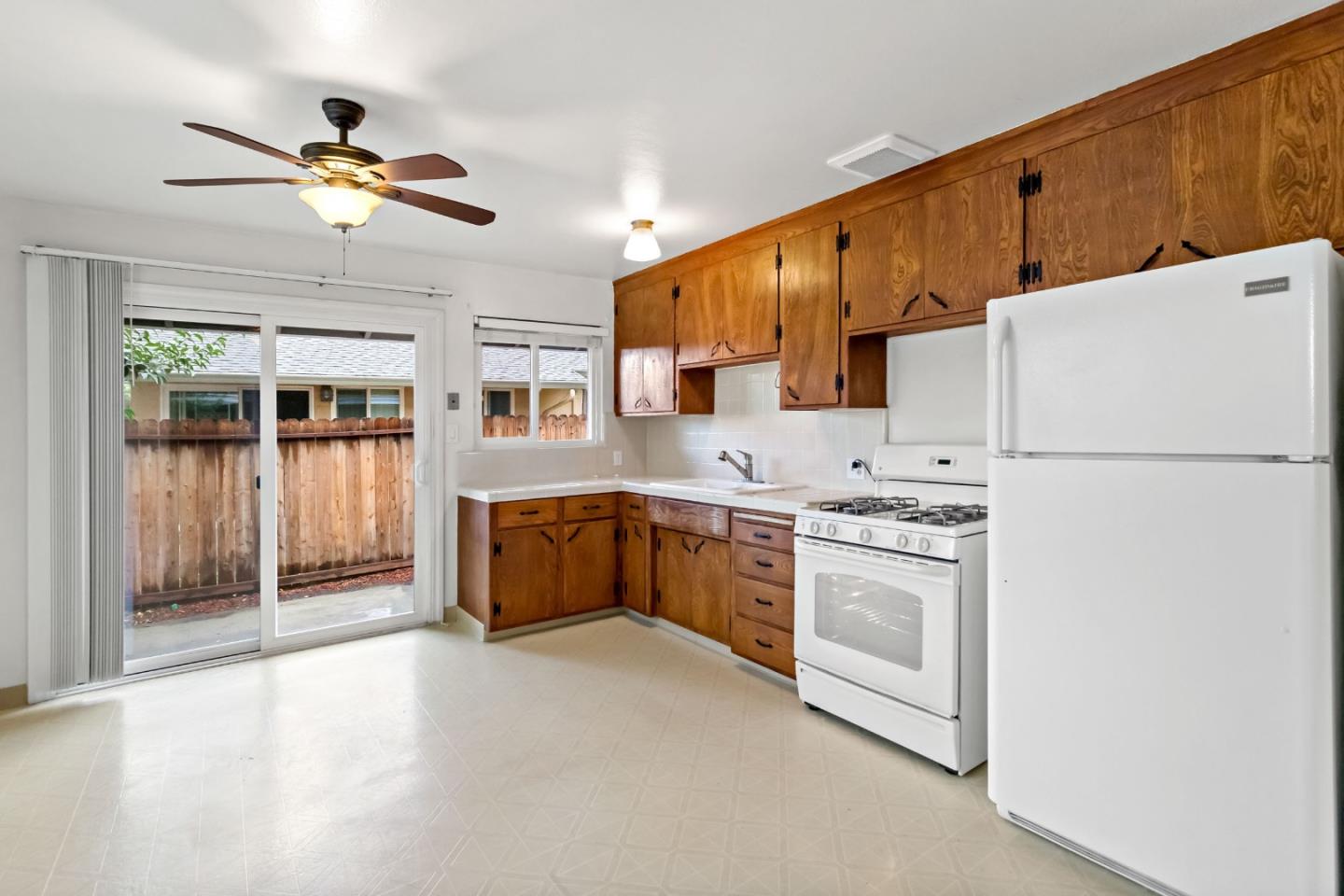 527 Easy Street Mountain View, CA 94043 - Photo 37 of 57 a kitchen with stainless steel appliances granite countertop a refrigerator a stove a sink dishwasher and a oven with white cabinets