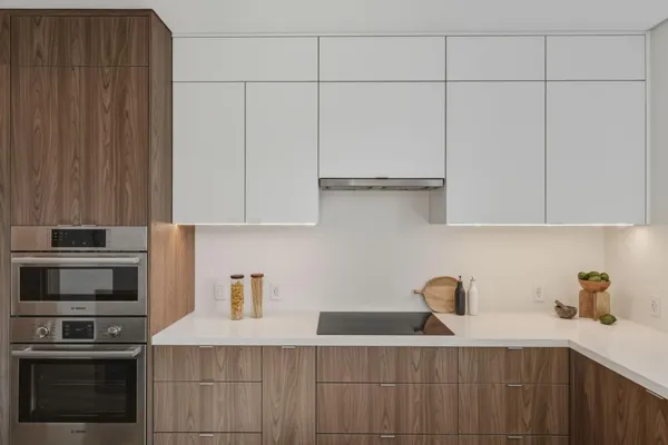 a kitchen with stainless steel appliances granite countertop a sink and a refrigerator
