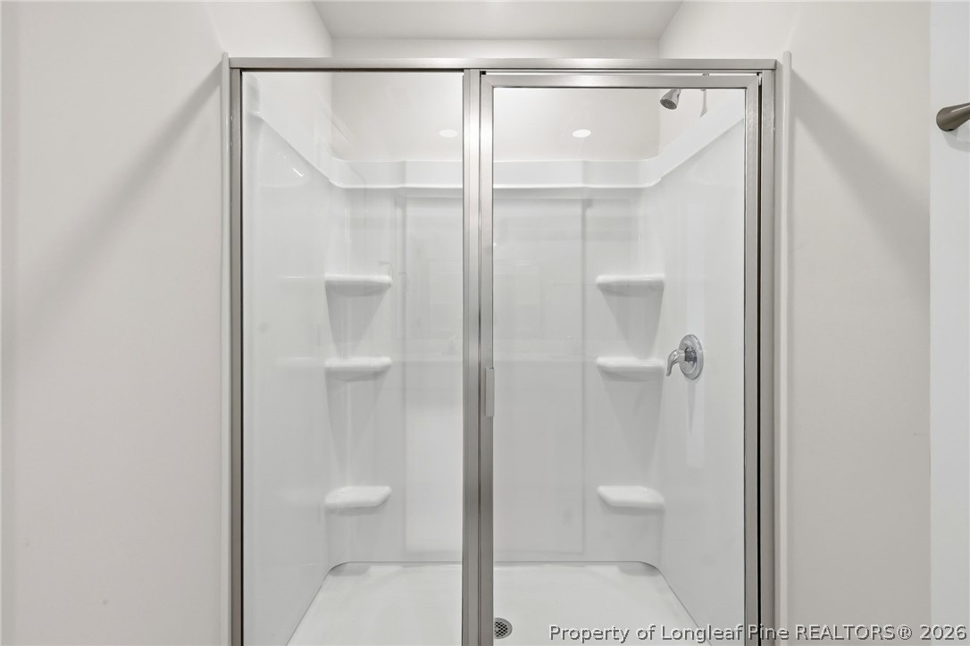 2208 Clydesmill Road Fayetteville, NC 28314 - Photo 22 of 26 a bathroom with a glass shower door