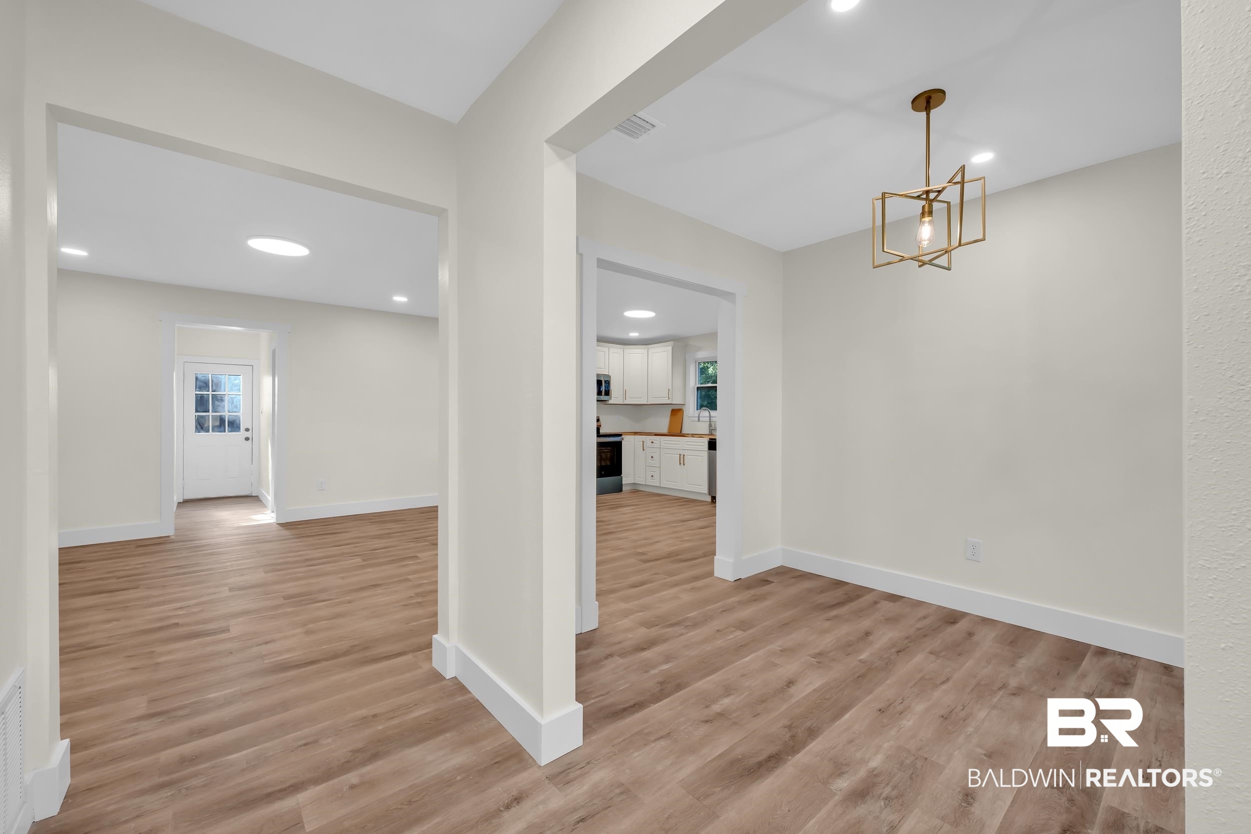 5109 McDonald Road Theodore, AL 36582 - Photo 4 of 21 Open-concept interior featuring wood-finish flooring, recessed lighting, and a modern geometric pendant light fixture