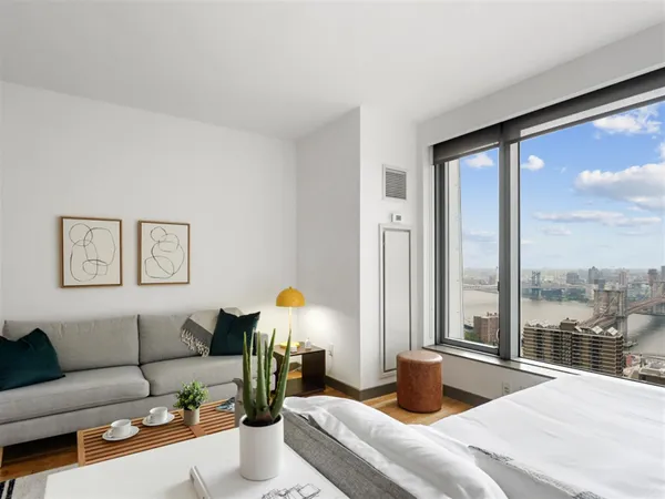 a bedroom with furniture and a large window