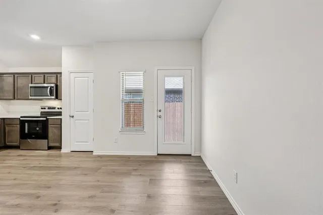 a view of a kitchen with an empty space and a window