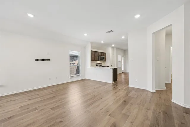 a view of a kitchen with wooden floor and a kitchen