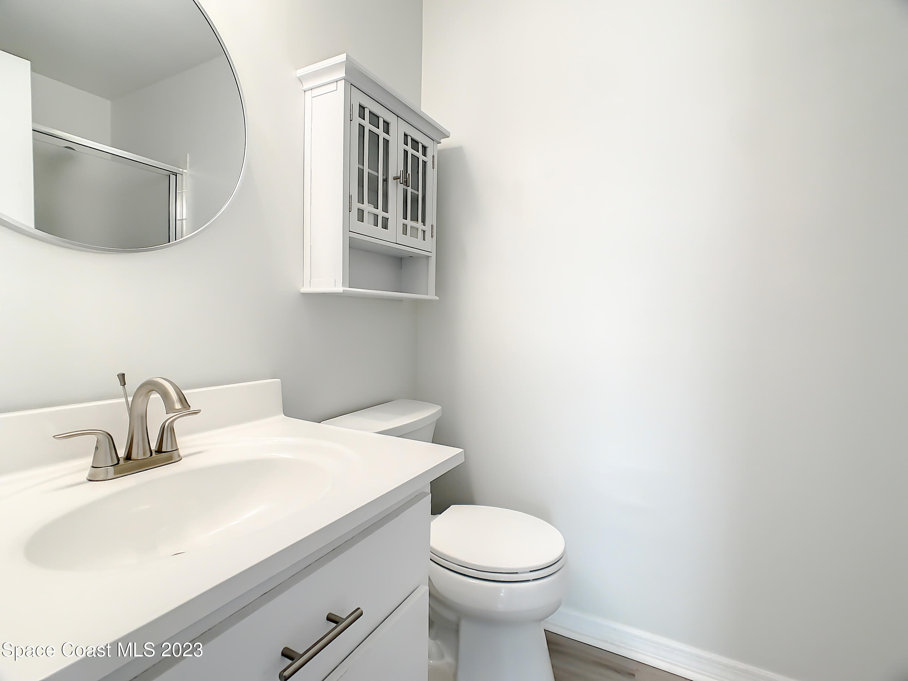 8520 Highway 1, Unit E9 Micco, FL 32976 - Photo 11 of 24 a bathroom with a sink a toilet and mirror