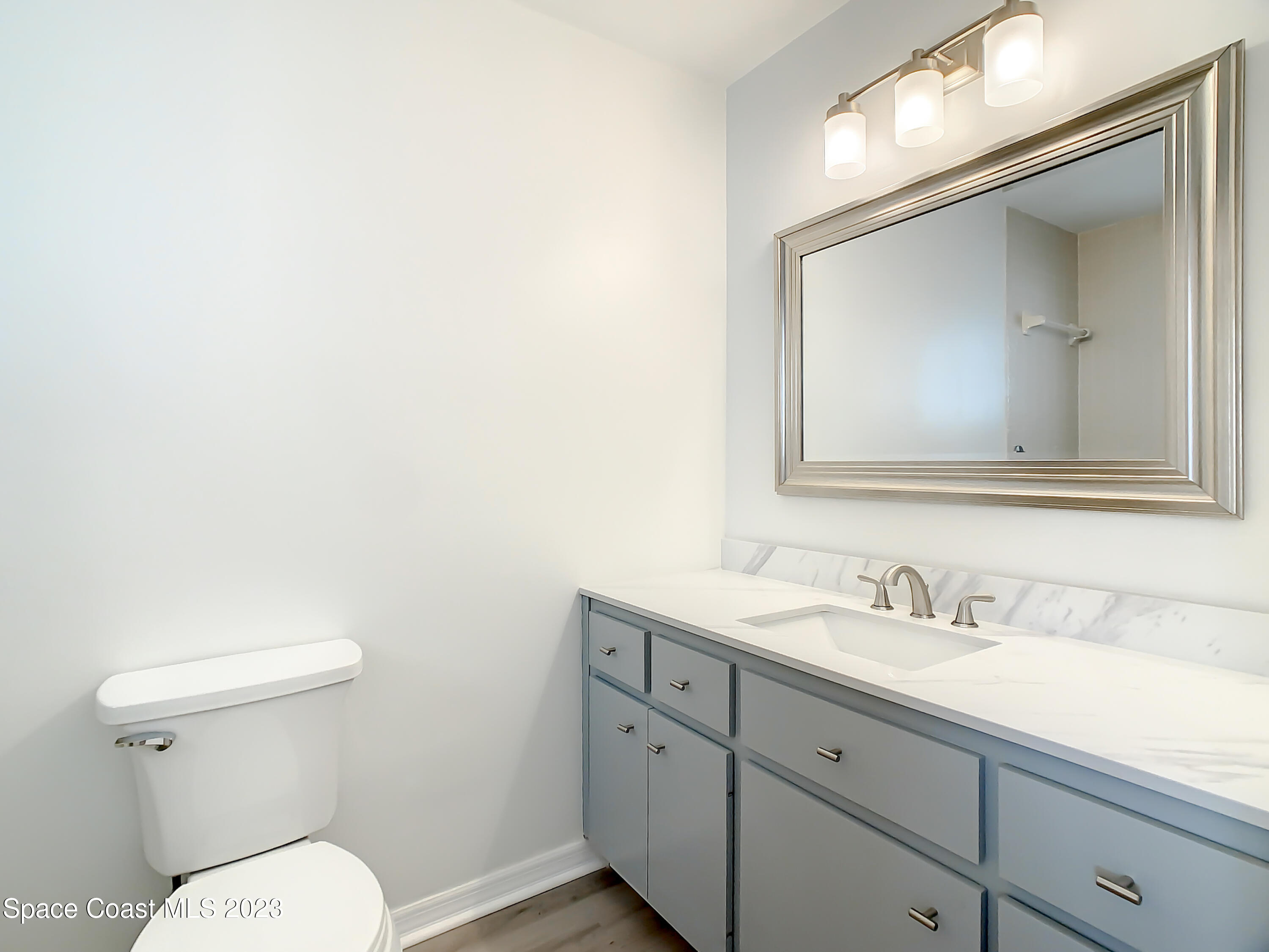 8520 Highway 1, Unit E9 Micco, FL 32976 - Photo 15 of 24 a bathroom with a toilet sink and mirror