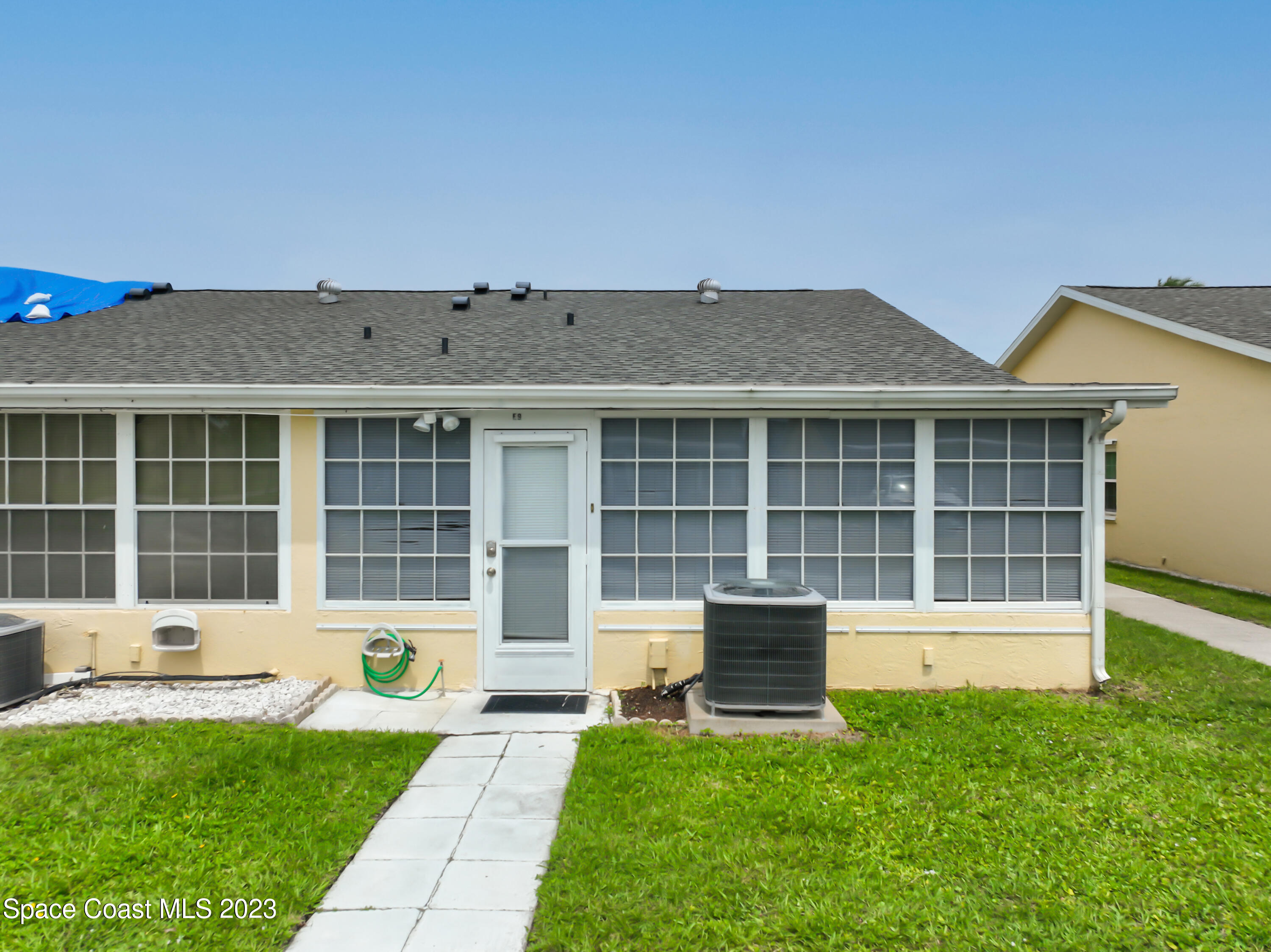8520 Highway 1, Unit E9 Micco, FL 32976 - Photo 21 of 24 a front view of a house with a yard