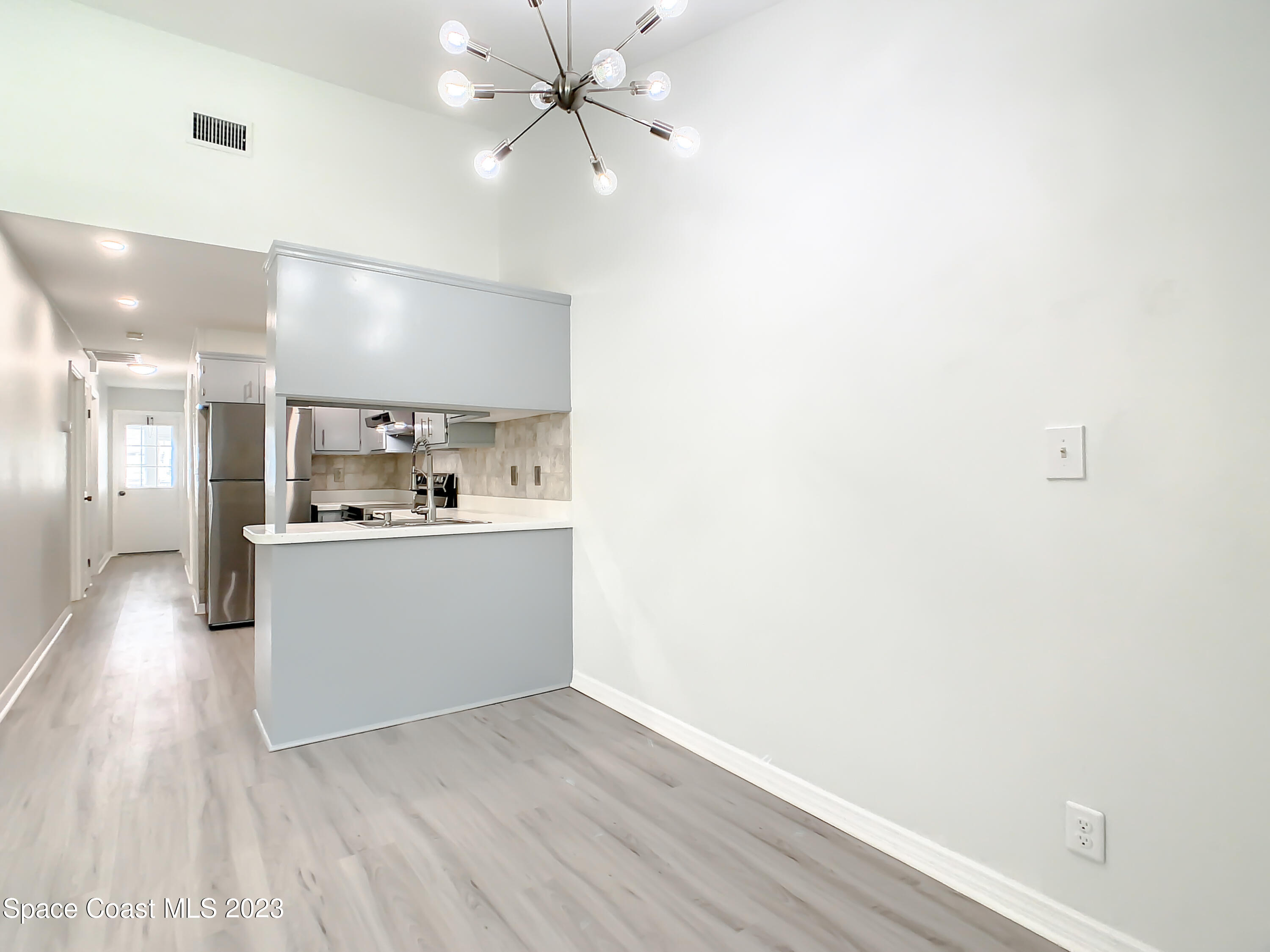 8520 Highway 1, Unit E9 Micco, FL 32976 - Photo 3 of 24 a view of a kitchen with a dishwasher and wooden floor