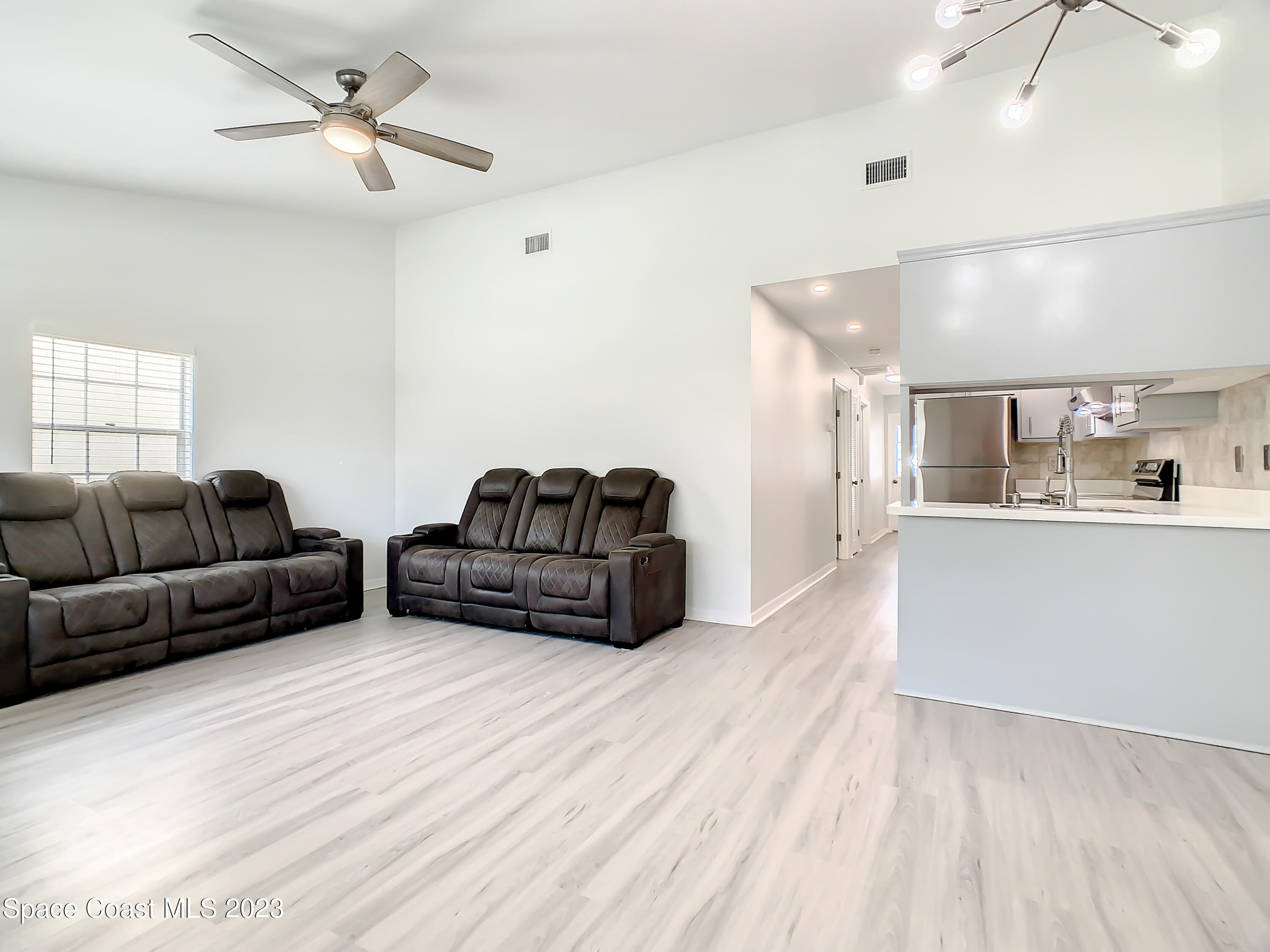 8520 Highway 1, Unit E9 Micco, FL 32976 - Photo 4 of 24 a living room with furniture a ceiling fan and a rug