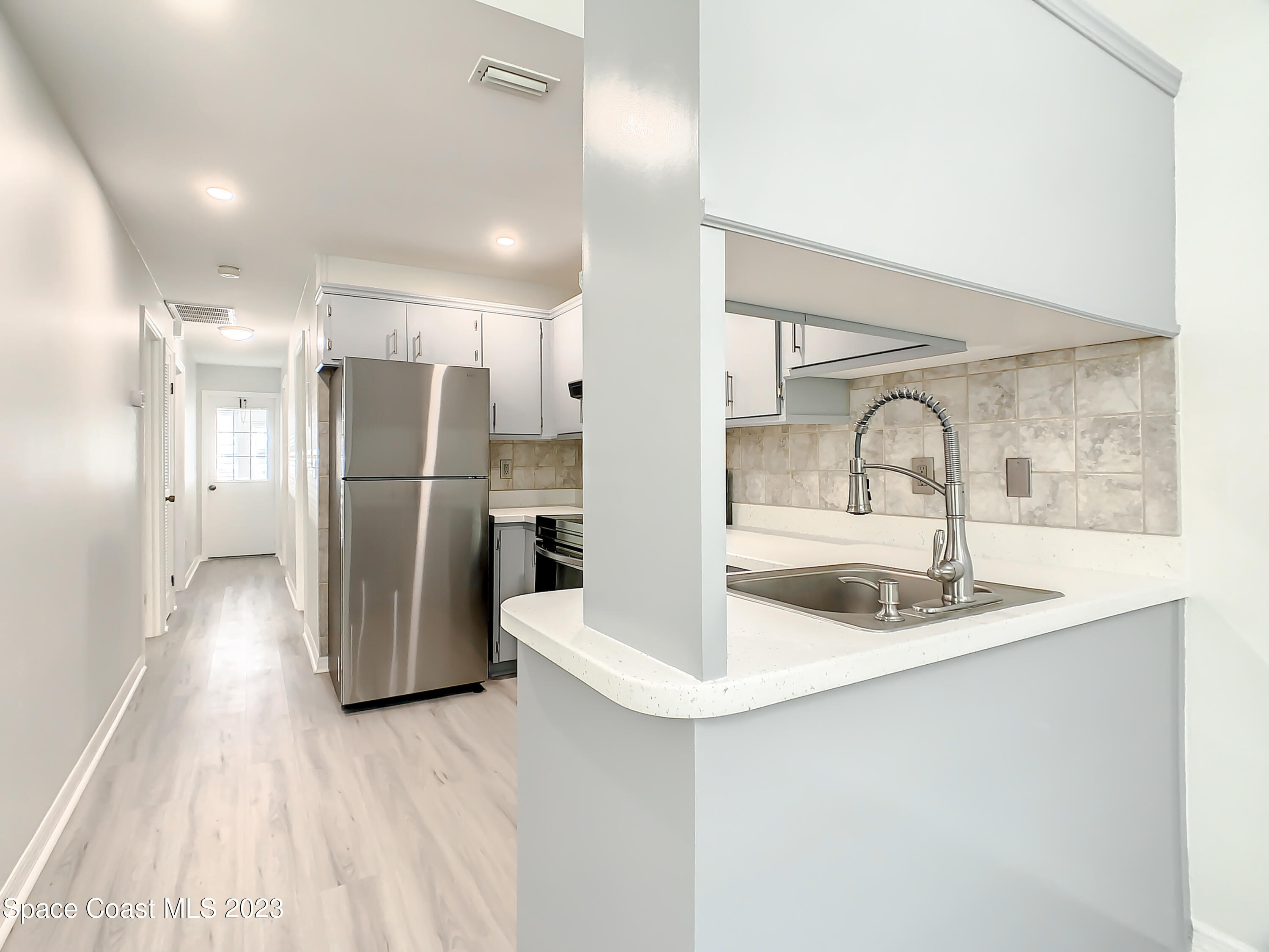 8520 Highway 1, Unit E9 Micco, FL 32976 - Photo 5 of 24 a kitchen with refrigerator and a sink