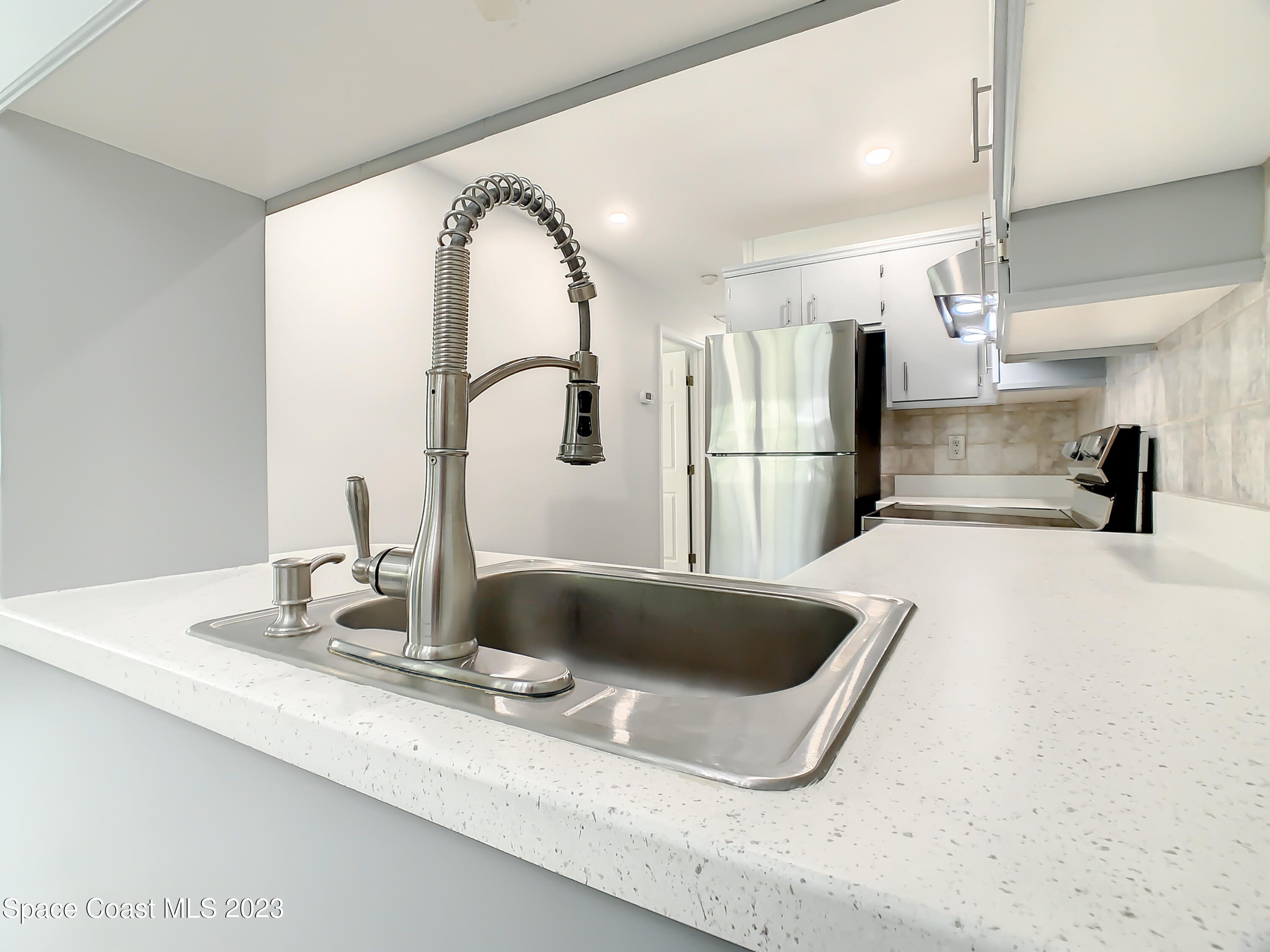 8520 Highway 1, Unit E9 Micco, FL 32976 - Photo 9 of 24 a kitchen with a sink and a refrigerator