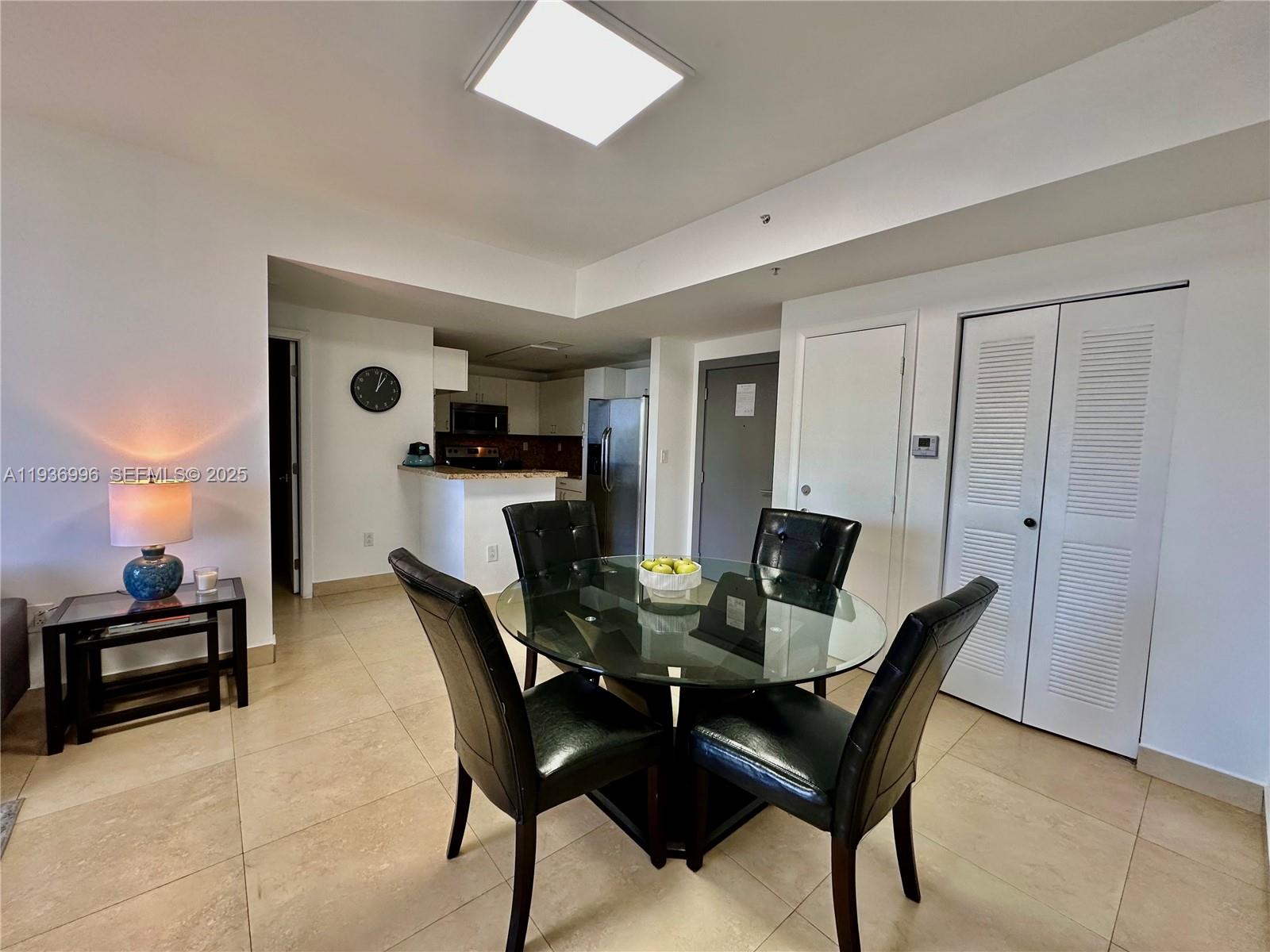 185 Southeast 14th Terrace, Unit 904 Miami, FL 33131 - Photo 5 of 19 a view of a dining room with furniture and a potted plant