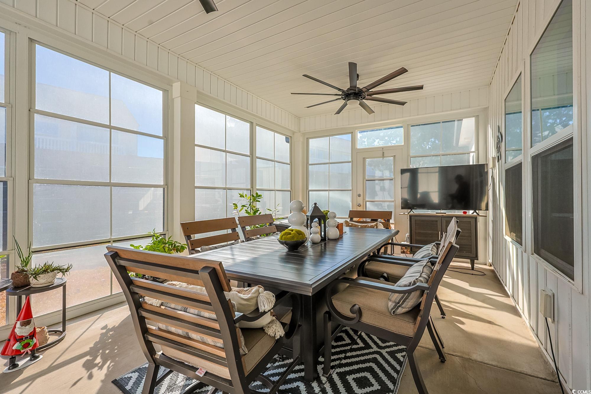 669 Pacific Commons Drive Surfside Beach, SC 29575 - Photo 16 of 36 Sunroom featuring a ceiling fan, outdoor dining area, and plenty of natural light