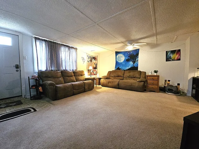 a living room with furniture a couch and a window
