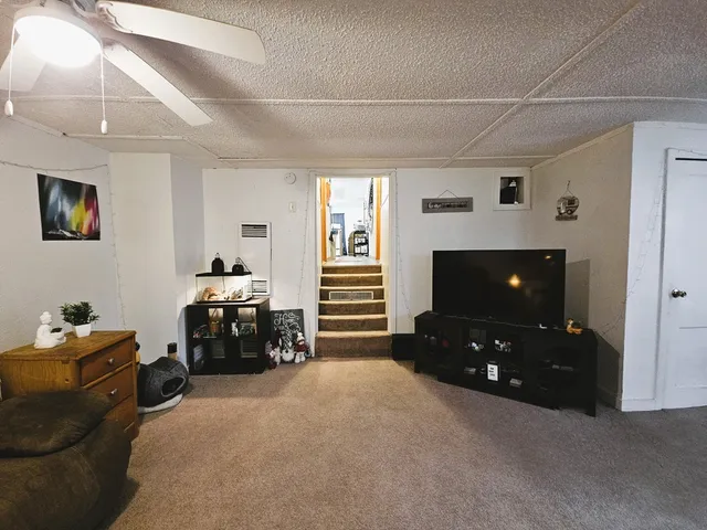 a bedroom with furniture and flat screen tv