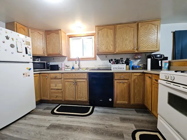 a kitchen with stainless steel appliances a stove a sink a refrigerator and cabinets