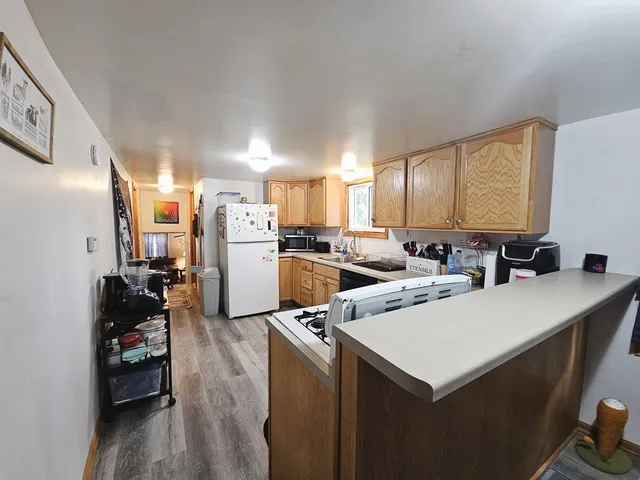 a kitchen with a refrigerator a stove and a sink