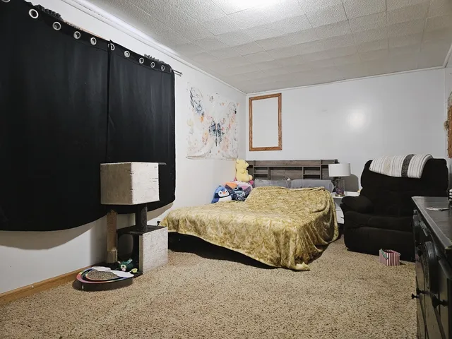 a bedroom with bed and window