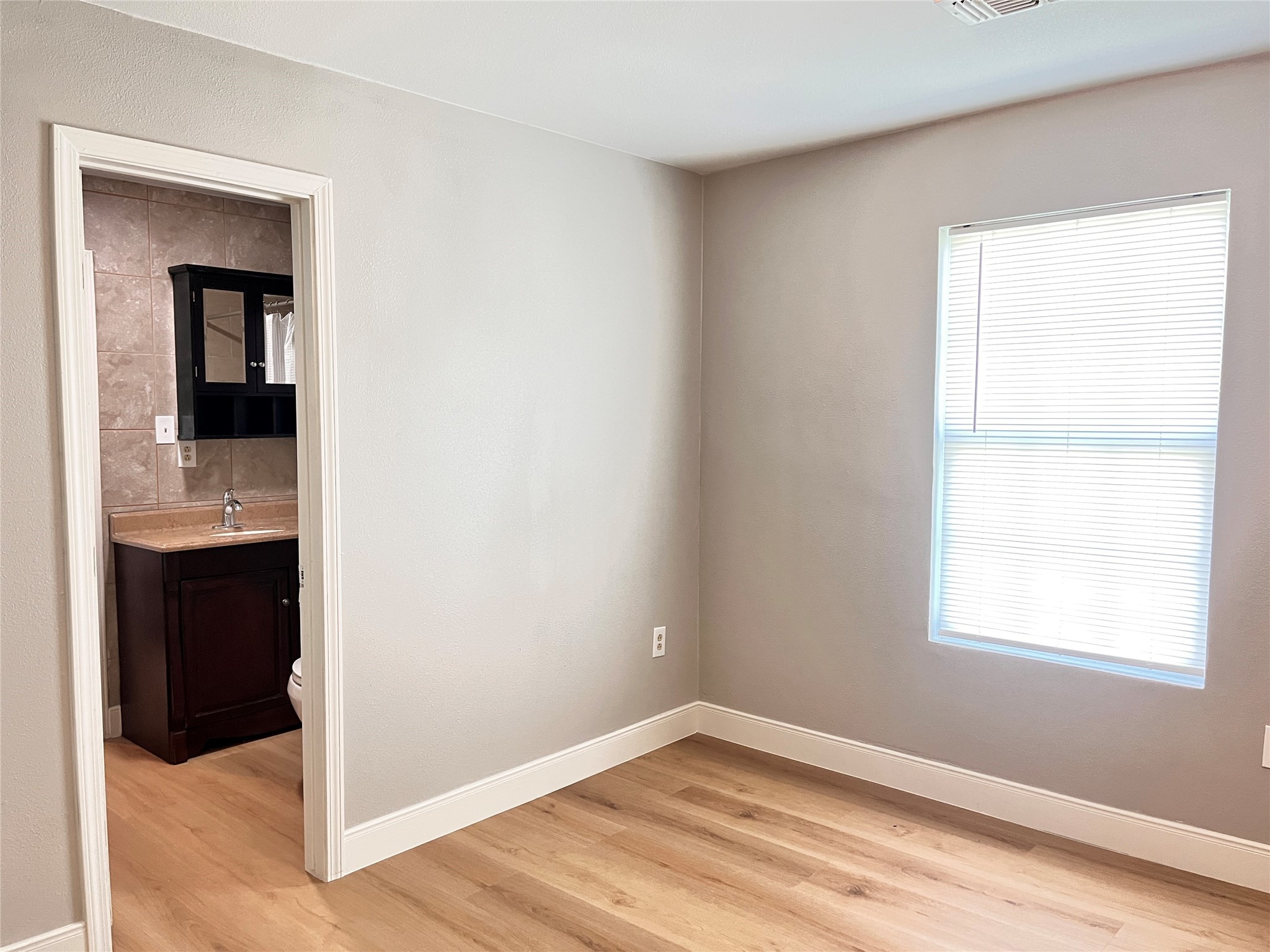 1010 Aurelia Lane Rosenberg, TX 77471 - Photo 21 of 29 a view of a kitchen with wooden floor and a window