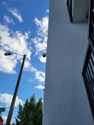 a kitchen with granite countertop a refrigerator and a stove top oven