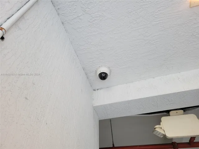 a kitchen with a refrigerator a microwave a sink and cabinets