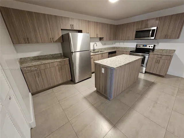 a stove top oven sitting inside of a kitchen