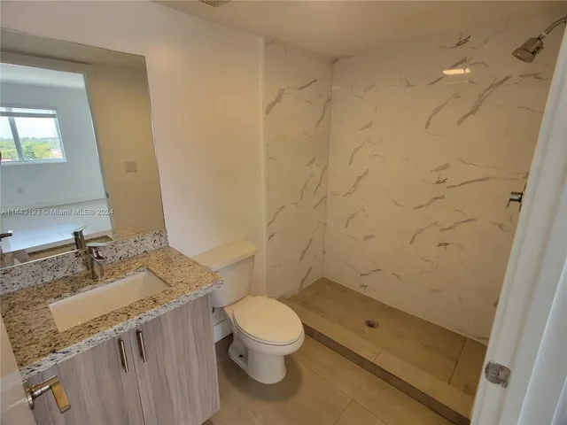 a view of a hallway to rooms and wooden floor