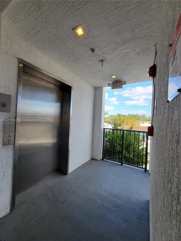 a view of parking garage with cars