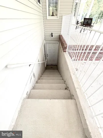 a view of a dining room with furniture a chandelier and wooden floor