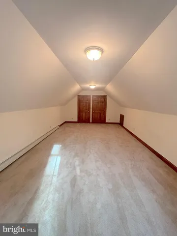 a kitchen with stainless steel appliances wooden floor dining table and chairs