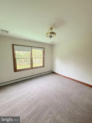 a living room with stainless steel appliances furniture cabinets and a wooden floor