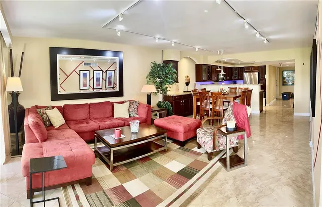 a living room with furniture a flat screen tv and a rug