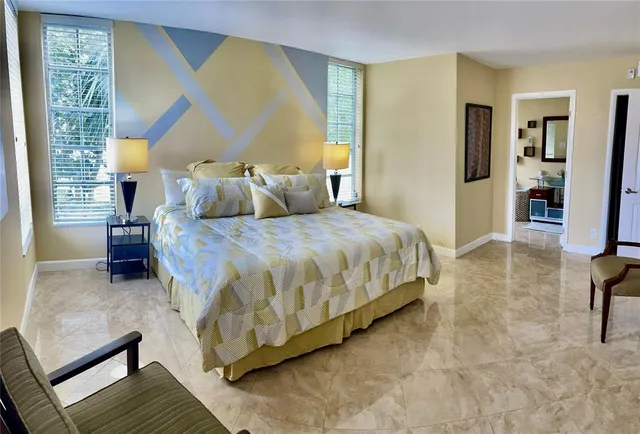 a bedroom with a bed and a chair