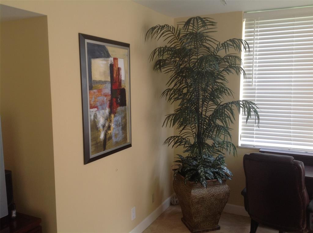 2681 South Course Drive, Unit 212 Pompano Beach, FL 33069 - Photo 13 of 16 a view of a hallway with a potted plant and a window