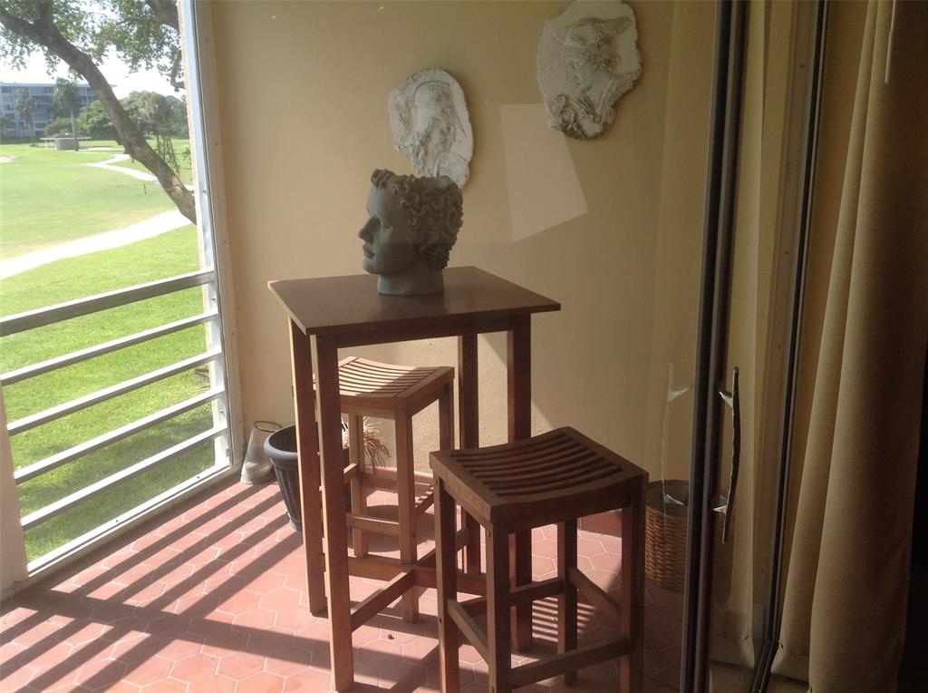 2681 South Course Drive, Unit 212 Pompano Beach, FL 33069 - Photo 14 of 16 a view of entryway with wooden door