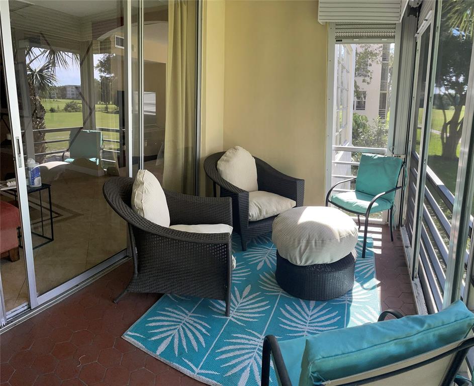 2681 South Course Drive, Unit 212 Pompano Beach, FL 33069 - Photo 16 of 16 a living room with furniture and a large window