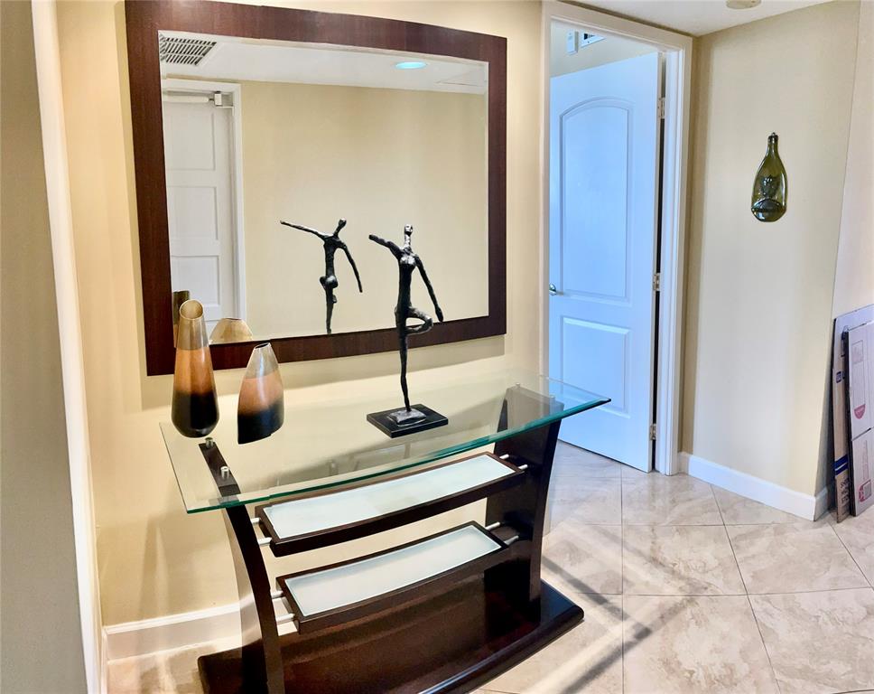 2681 South Course Drive, Unit 212 Pompano Beach, FL 33069 - Photo 2 of 16 a view of hallway with a mirror and furniture