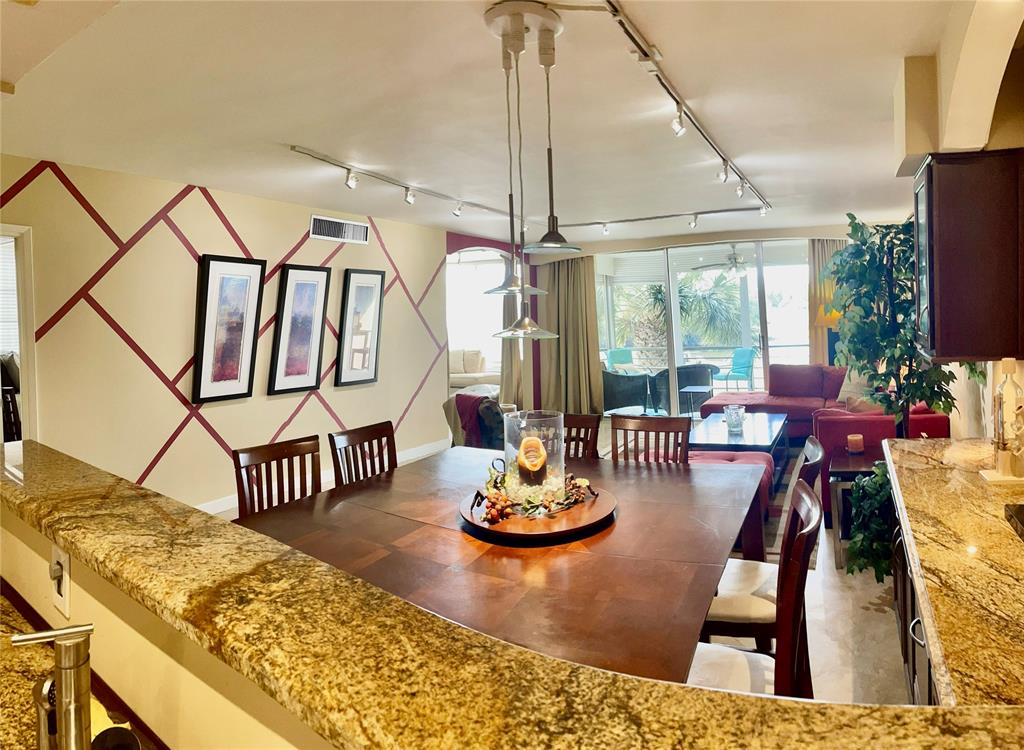 2681 South Course Drive, Unit 212 Pompano Beach, FL 33069 - Photo 5 of 16 a view of a dining room with furniture window and wooden floor