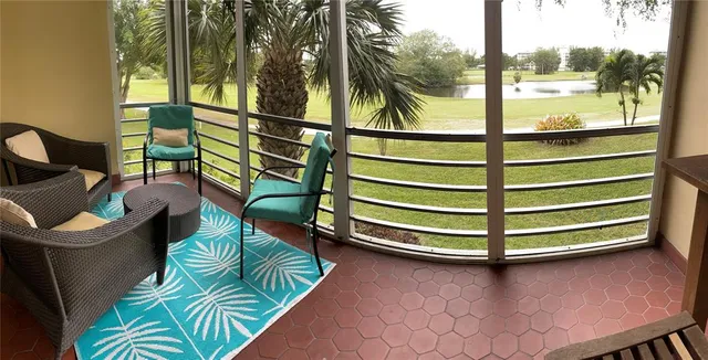 a balcony with chairs and a table