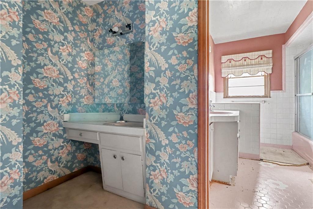 1315 Fairview Road Ellenwood, GA 30294 - Photo 13 of 34 a bathroom with a sink a toilet and shower