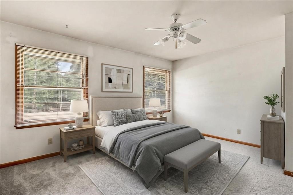 1315 Fairview Road Ellenwood, GA 30294 - Photo 14 of 34 a bedroom with a bed and a chandelier