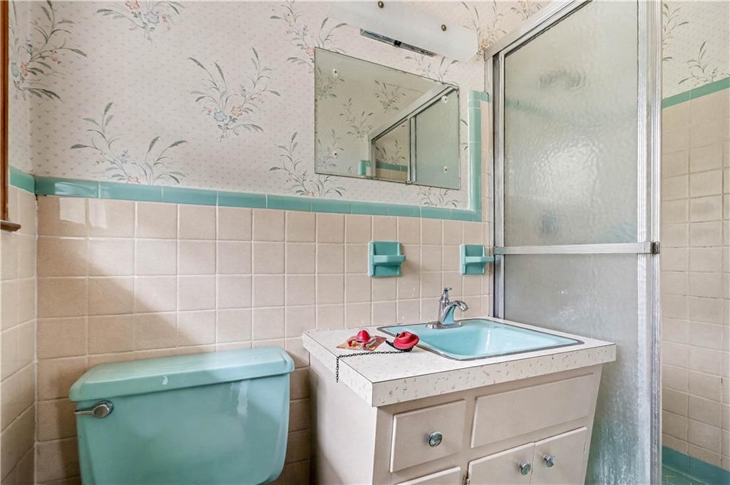 1315 Fairview Road Ellenwood, GA 30294 - Photo 18 of 34 a bathroom with a sink and a mirror