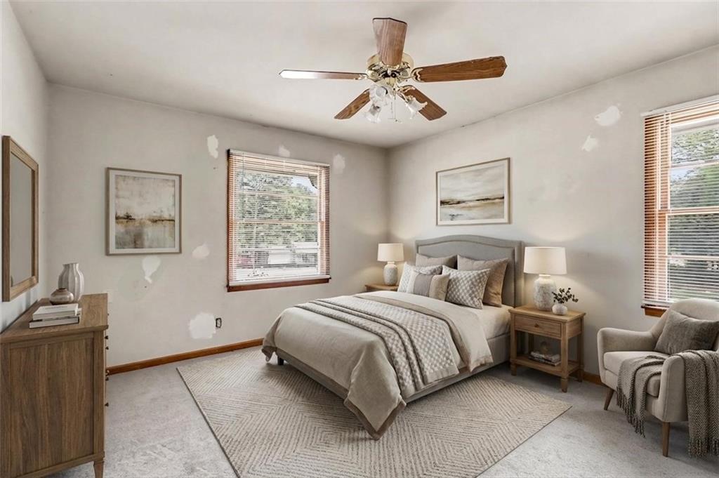 1315 Fairview Road Ellenwood, GA 30294 - Photo 19 of 34 a bedroom with a large bed and a window